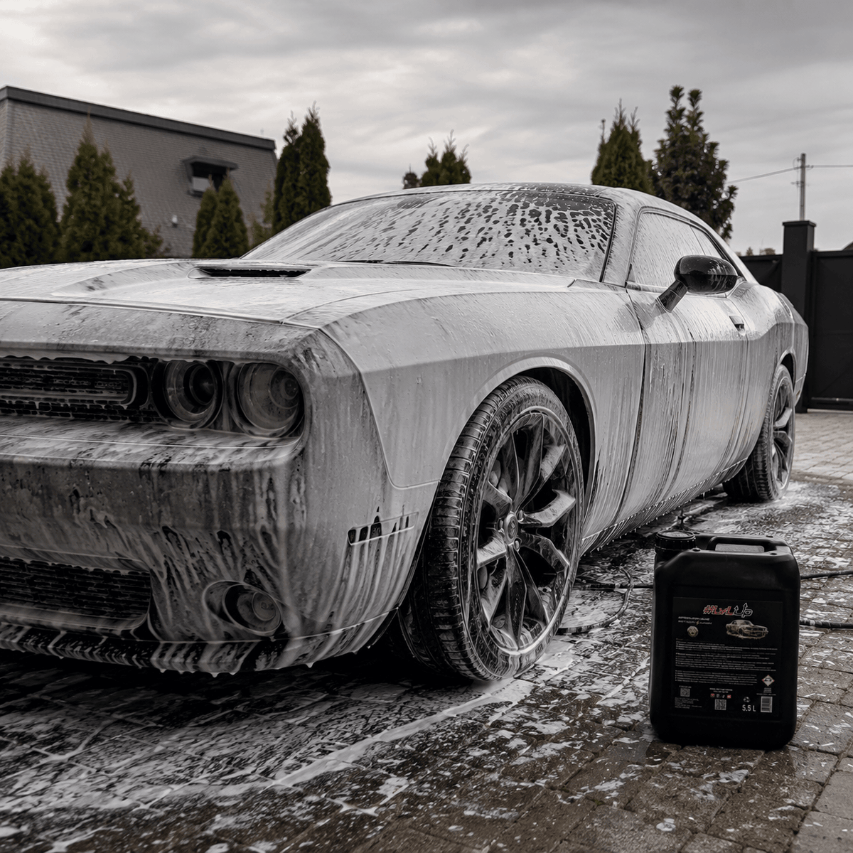 A car covered in foam during the pre-wash phase using PREWASH.EXE STAGE1 WASH for effective dirt removal.