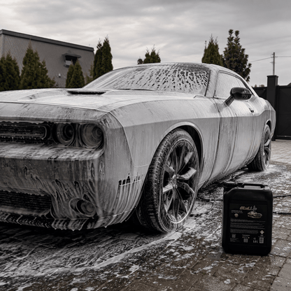 A car covered in foam during the pre-wash phase using PREWASH.EXE STAGE1 WASH for effective dirt removal.