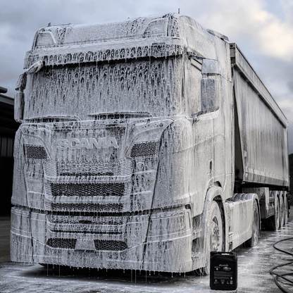 Scania truck covered in foam during the PREWASH.EXE STAGE1 WASH cleaning process.